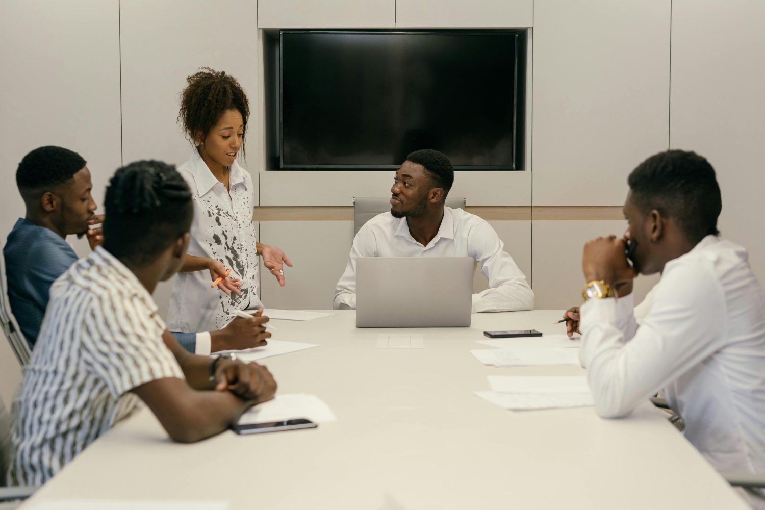 A diverse team of professionals collaborating in a modern office meeting environment.